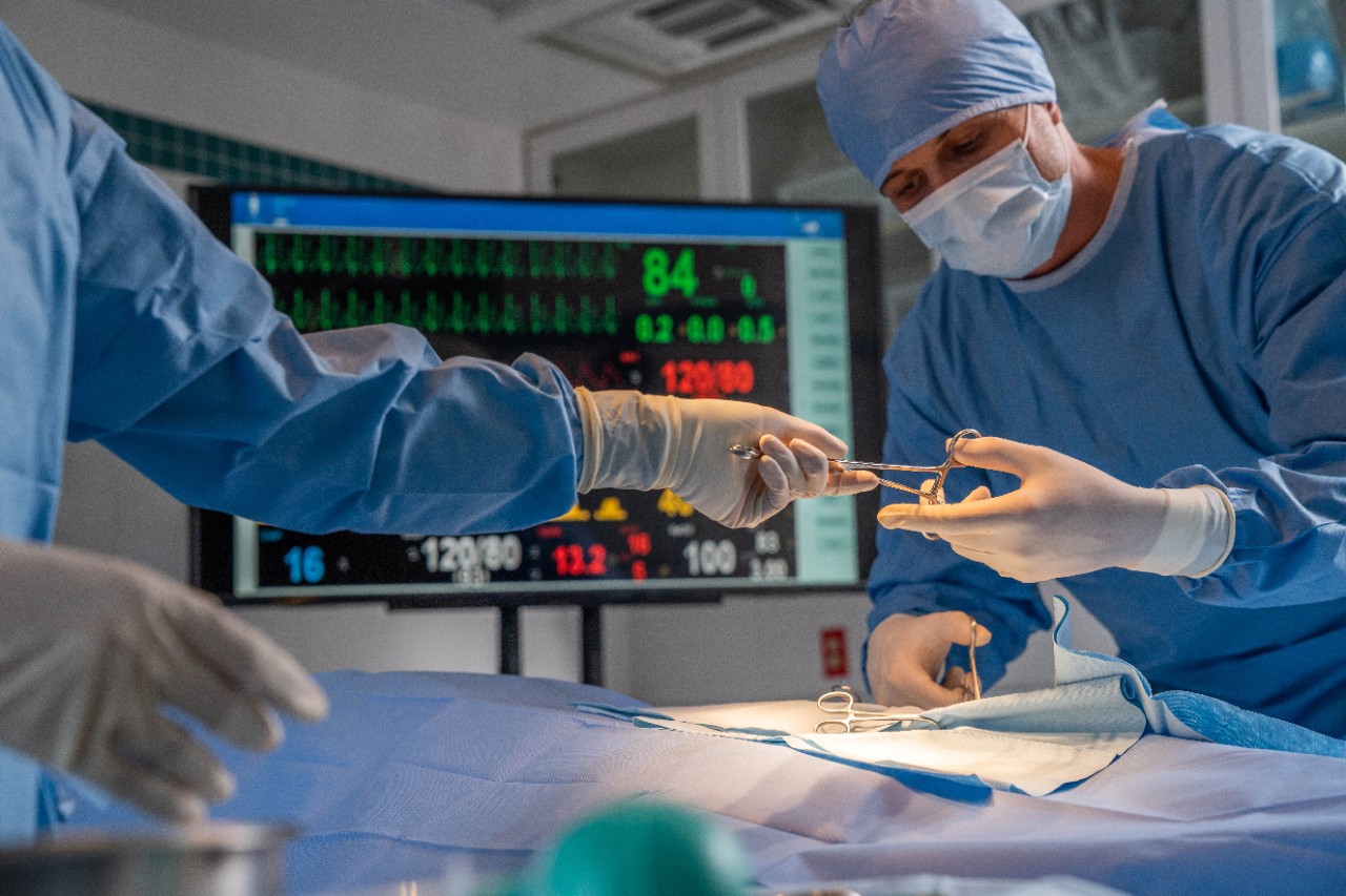 surgeon at work with patient monitoring in background