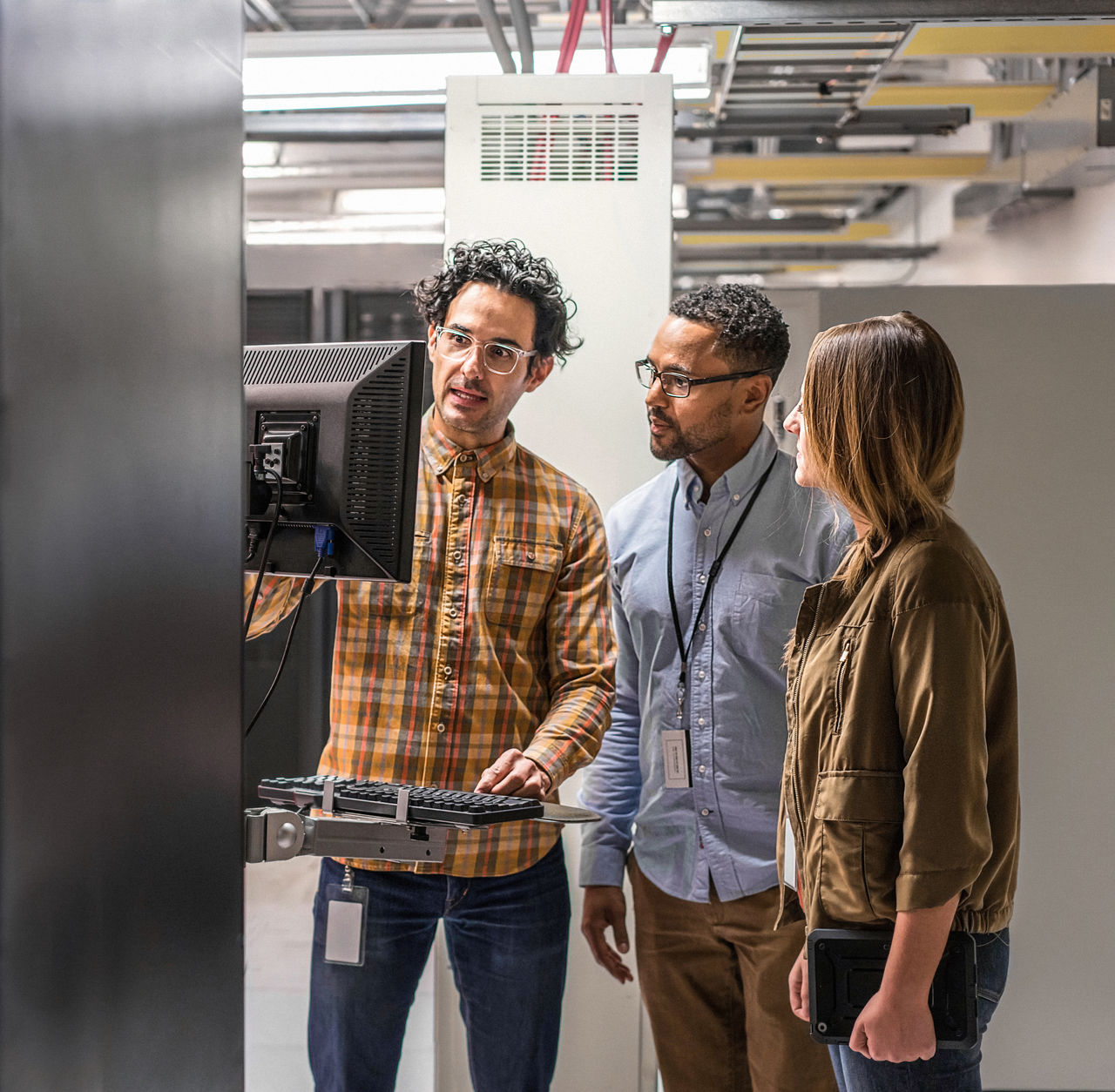 Group of IT workers talking over a device