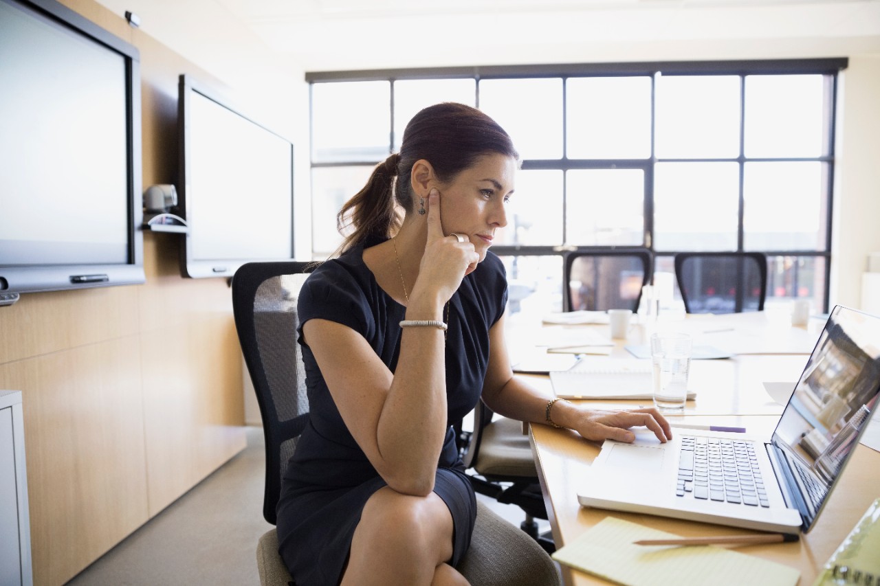 Businesswoman working at laptop in conference room