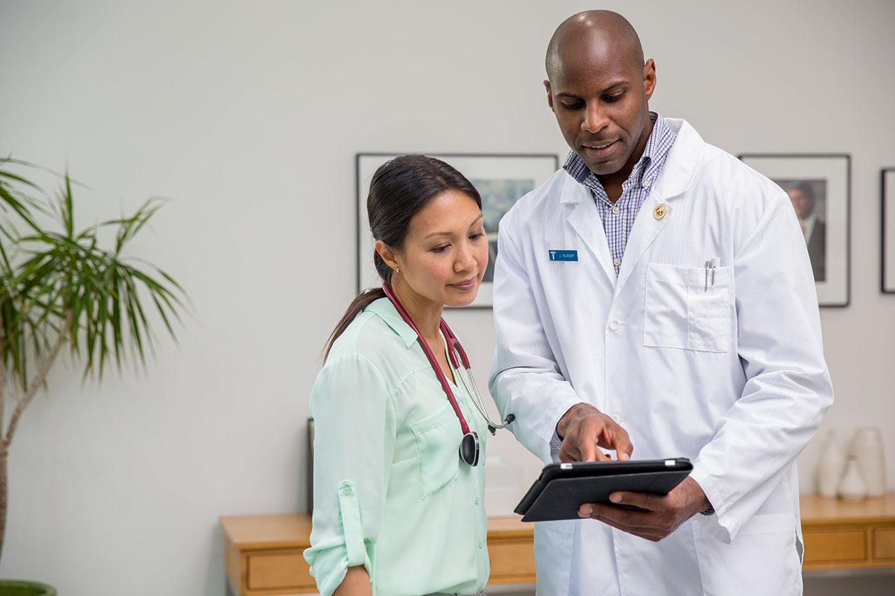 Doctors discuss information on tablet