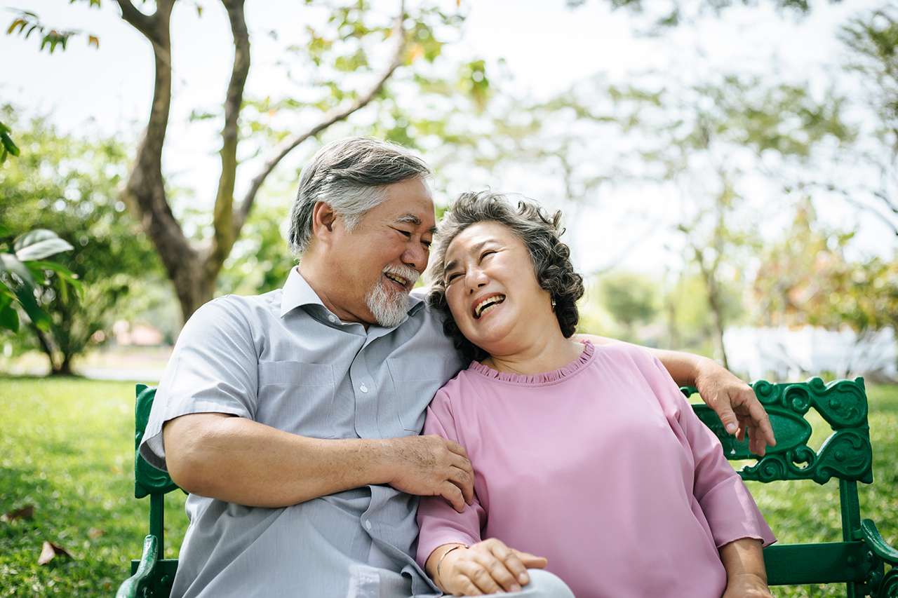 957120618 healthy senior couple relaxing  seats on the bench in the park