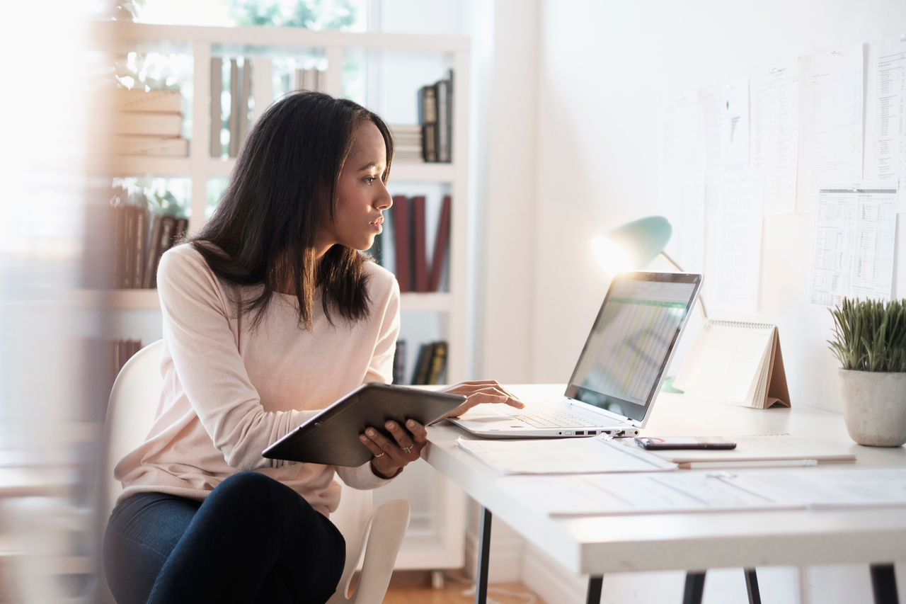 Businesswoman using laptop at home