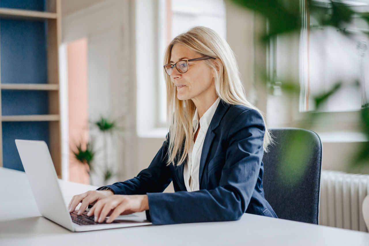 Businesswoman working at computer in modern office