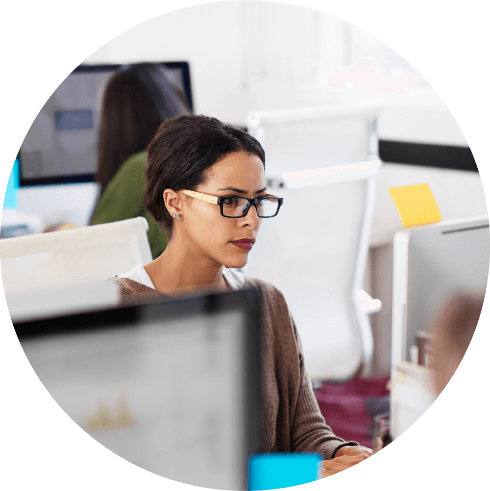 Woman sitting at desk working on computer