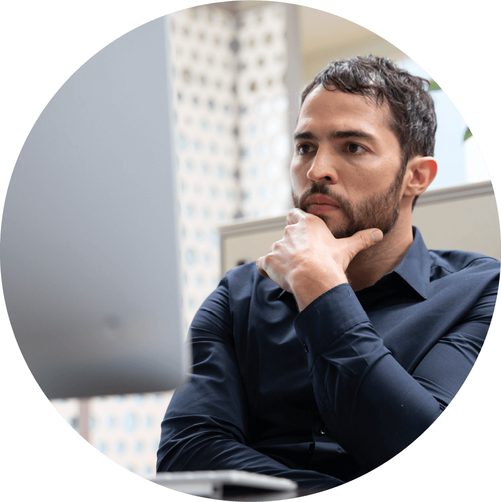 Man looking thoughtful at computer screen